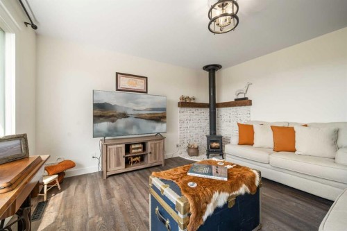 94075 Range Road 115, Burdett, AB - Indoor Photo Showing Living Room With Fireplace