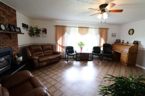 145004 Rr164, Vauxhall, AB - Indoor Photo Showing Living Room With Fireplace