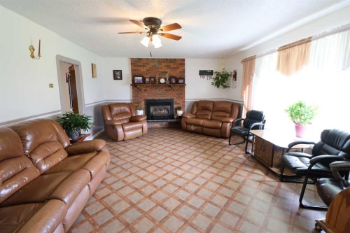 145004 Rr164, Vauxhall, AB - Indoor Photo Showing Living Room With Fireplace