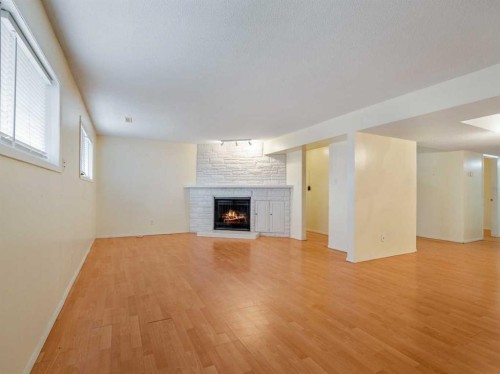 120S 300E, Raymond, AB - Indoor Photo Showing Living Room With Fireplace