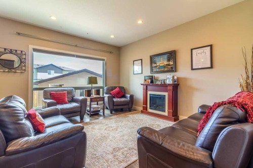 679 Keystone Chase West, Lethbridge, AB - Indoor Photo Showing Living Room With Fireplace