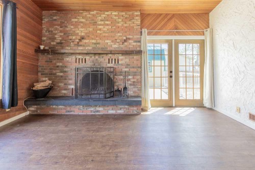 67 E 200 S, Raymond, AB - Indoor Photo Showing Living Room With Fireplace