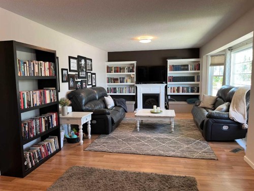 235S 50 West, Raymond, AB - Indoor Photo Showing Living Room With Fireplace