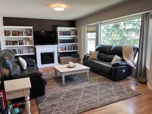 235S 50 West, Raymond, AB - Indoor Photo Showing Living Room With Fireplace