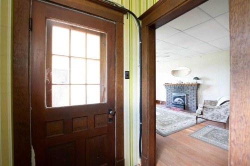 5 4 Street, Champion, AB - Indoor Photo Showing Other Room With Fireplace
