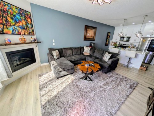 83 Harvest Square, Claresholm, AB - Indoor Photo Showing Living Room With Fireplace