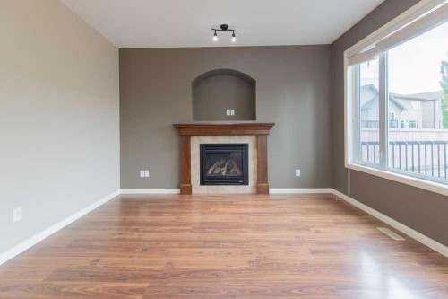 5 Coalbanks Link West, Lethbridge, AB - Indoor Photo Showing Living Room With Fireplace