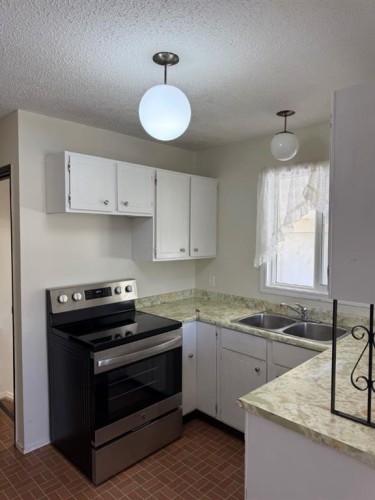 232 Rubie Crescent, Nobleford, AB - Indoor Photo Showing Kitchen With Double Sink
