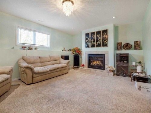 827 Kodiak Bay North, Lethbridge, AB - Indoor Photo Showing Living Room With Fireplace