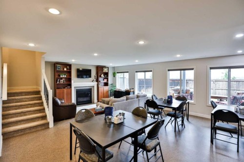 865 Atlantic Cove West, Lethbridge, AB - Indoor Photo Showing Other Room With Fireplace