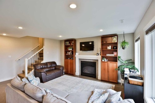 865 Atlantic Cove West, Lethbridge, AB - Indoor Photo Showing Living Room With Fireplace
