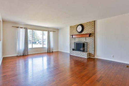 96 Oxford Road West, Lethbridge, AB - Indoor Photo Showing Living Room With Fireplace