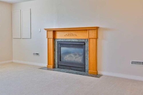 96 Oxford Road West, Lethbridge, AB - Indoor Photo Showing Other Room With Fireplace