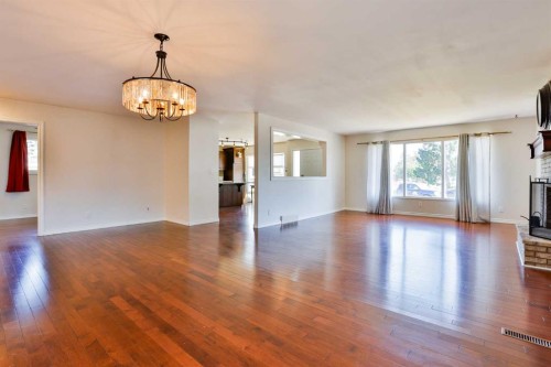 96 Oxford Road West, Lethbridge, AB - Indoor Photo Showing Living Room With Fireplace