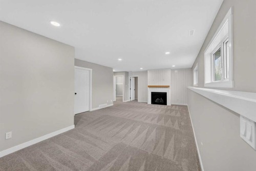74 Riverpark Boulevard West, Lethbridge, AB - Indoor Photo Showing Other Room With Fireplace
