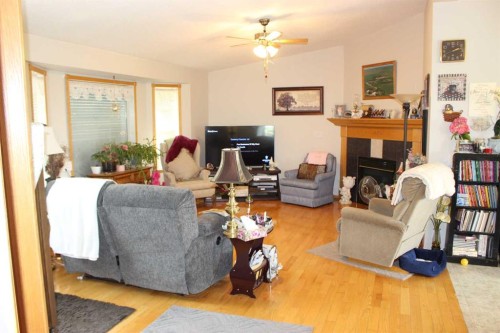 61048 Hwy 844, Raymond, AB - Indoor Photo Showing Living Room With Fireplace