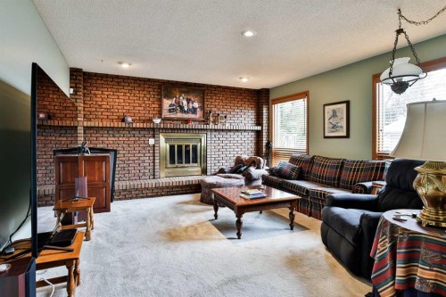 2265 27 Avenue South, Lethbridge, AB - Indoor Photo Showing Living Room With Fireplace