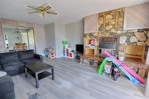 4810 57 Ave, Taber, AB - Indoor Photo Showing Living Room With Fireplace