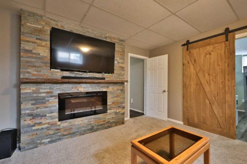 4602 6 Street, Coalhurst, AB - Indoor Photo Showing Living Room With Fireplace