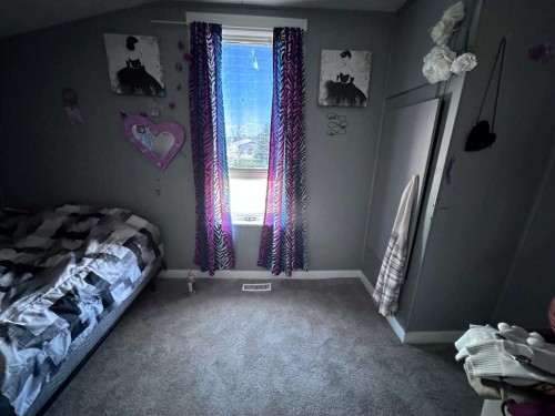 61 2 Avenue East, Cardston, AB - Indoor Photo Showing Bedroom