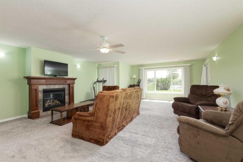 334 Mt Sunburst Way West, Lethbridge, AB - Indoor Photo Showing Living Room With Fireplace