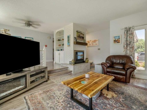 66 Pheasant Road North, Lethbridge, AB - Indoor Photo Showing Living Room With Fireplace