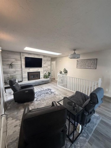 3733 21 Avenue South, Lethbridge, AB - Indoor Photo Showing Living Room With Fireplace