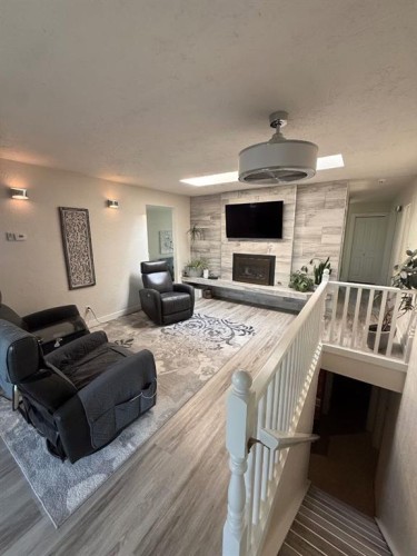 3733 21 Avenue South, Lethbridge, AB - Indoor Photo Showing Living Room With Fireplace