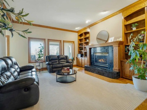 90013 212, Rural Lethbridge County, AB - Indoor Photo Showing Living Room With Fireplace