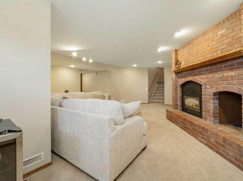 90013 212, Rural Lethbridge County, AB - Indoor Photo Showing Living Room With Fireplace