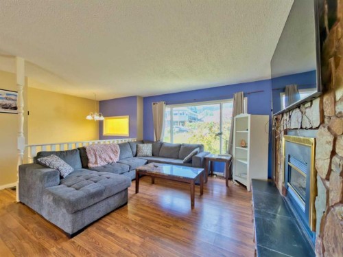 8534 21 Avenue, Coleman, AB - Indoor Photo Showing Living Room With Fireplace