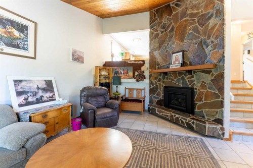 210 Ojibwa Place West, Lethbridge, AB - Indoor Photo Showing Living Room With Fireplace
