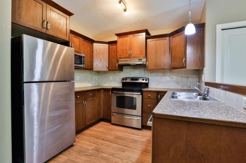 215 Haru Moriyama Place North, Lethbridge, AB - Indoor Photo Showing Kitchen With Double Sink