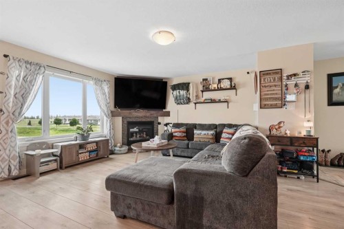 648 Parkside Green, Coaldale, AB - Indoor Photo Showing Living Room With Fireplace