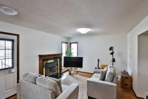 936 13 Street South, Lethbridge, AB - Indoor Photo Showing Living Room With Fireplace