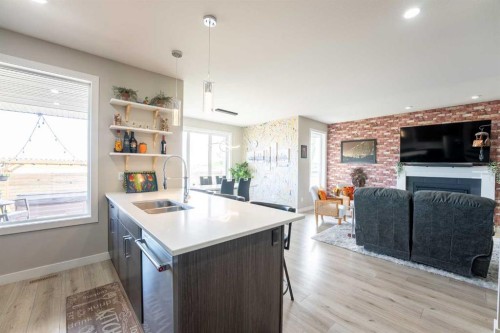 437 Devonia Way West, Lethbridge, AB - Indoor Photo Showing Kitchen With Fireplace With Double Sink