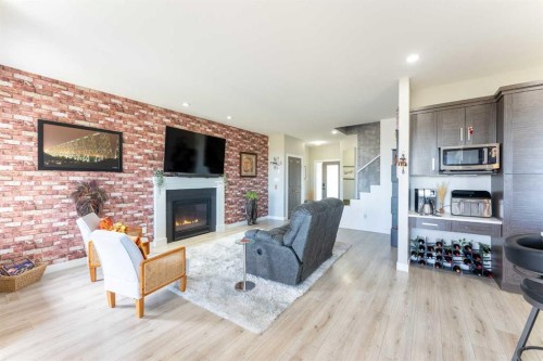 437 Devonia Way West, Lethbridge, AB - Indoor Photo Showing Living Room With Fireplace