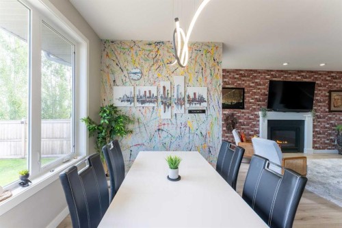 437 Devonia Way West, Lethbridge, AB - Indoor Photo Showing Dining Room With Fireplace