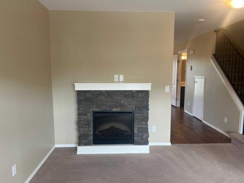 18-45 Keystone Terrace West, Lethbridge, AB - Indoor Photo Showing Living Room With Fireplace