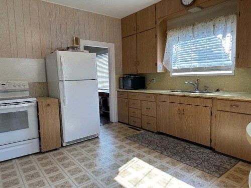 8017 22 Avenue, Coleman, AB - Indoor Photo Showing Kitchen With Double Sink