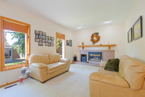 110 Heritage Boulevard West, Lethbridge, AB - Indoor Photo Showing Living Room With Fireplace