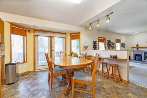 110 Heritage Boulevard West, Lethbridge, AB - Indoor Photo Showing Dining Room With Fireplace