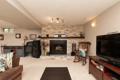 10 Seneca Place West, Lethbridge, AB - Indoor Photo Showing Living Room With Fireplace