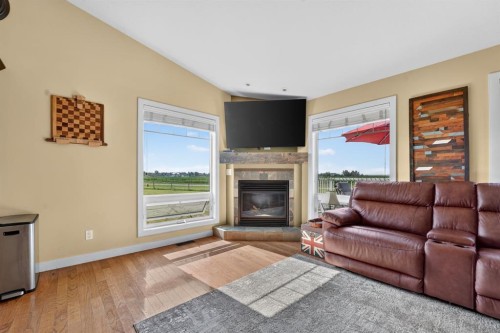 65004 Range Road 19-5, Stirling, AB - Indoor Photo Showing Living Room With Fireplace