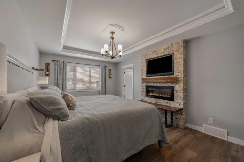 696 Sixmile Crescent South, Lethbridge, AB - Indoor Photo Showing Bedroom With Fireplace