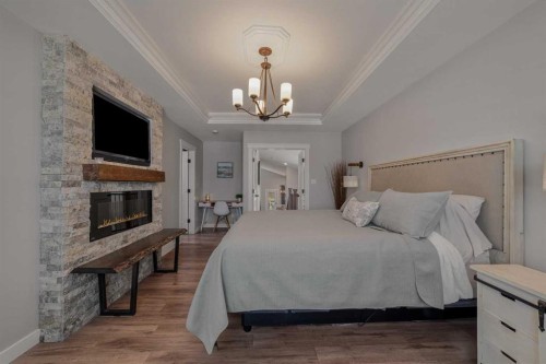 696 Sixmile Crescent South, Lethbridge, AB - Indoor Photo Showing Bedroom With Fireplace