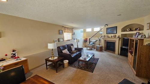 414 Gateway Crescent South, Lethbridge, AB - Indoor Photo Showing Living Room With Fireplace