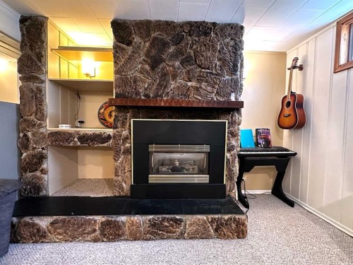 1806 13 Avenue South, Lethbridge, AB - Indoor Photo Showing Living Room With Fireplace