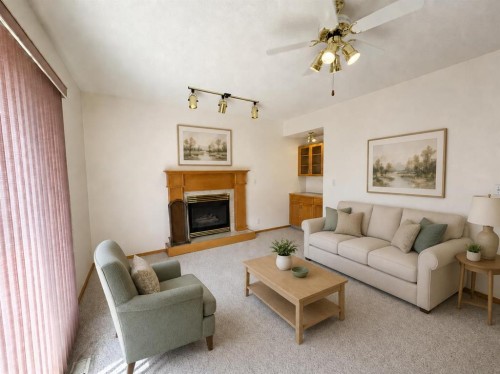 241 Fairway Drive, Coaldale, AB - Indoor Photo Showing Living Room With Fireplace