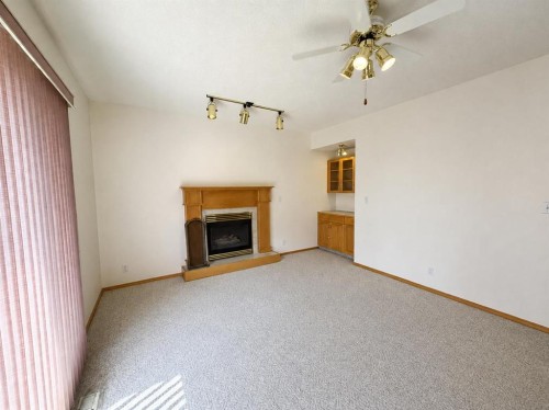241 Fairway Drive, Coaldale, AB - Indoor Photo Showing Living Room With Fireplace